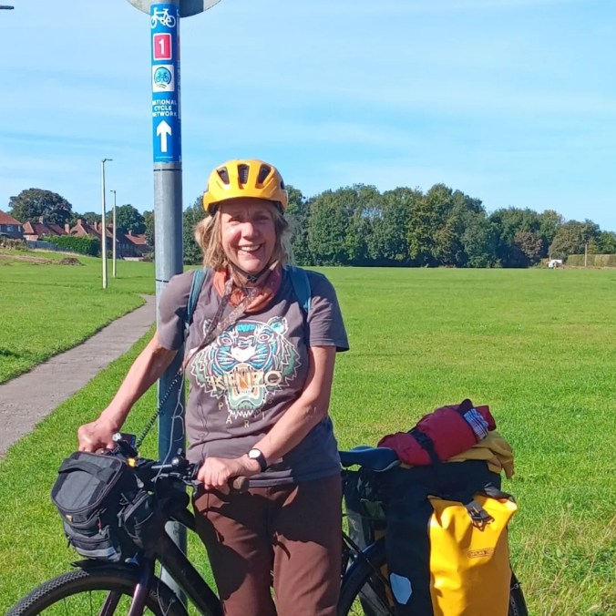 Debs stood in front of a National Cycle Route sign on the Cinder Track near Scarborough 